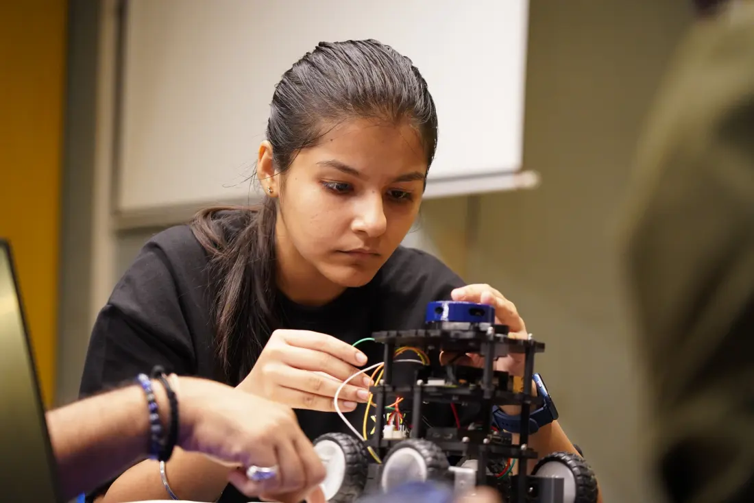 A student adjusting the LiDAR on a TortoiseBot kit at a My Equation session
